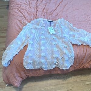 Zara semi-sheer long sleeved shirt with round collar and tied v-neck front.